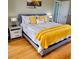 King-size bed with yellow blanket and patterned bedding in a serene bedroom at 209 Palmetto Blvd, Edisto Beach, SC 29438