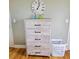 White dresser with five drawers and black handles at 209 Palmetto Blvd, Edisto Beach, SC 29438