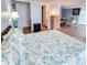 Bedroom with seashell bedding and view of kitchenette and dining area at 209 Palmetto Blvd, Edisto Beach, SC 29438