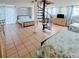 Two bedrooms, tiled floors, coastal bedding, and a spiral staircase at 209 Palmetto Blvd, Edisto Beach, SC 29438
