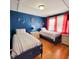 Twin bedroom with nautical decor and hardwood floors at 209 Palmetto Blvd, Edisto Beach, SC 29438