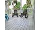 Relaxing deck with two rocking chairs and a view of lush greenery at 209 Palmetto Blvd, Edisto Beach, SC 29438
