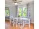 Bright dining room featuring a farmhouse table and chairs, and large windows at 209 Palmetto Blvd, Edisto Beach, SC 29438