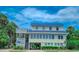 Two-story beach home with a metal roof and spacious deck at 209 Palmetto Blvd, Edisto Beach, SC 29438