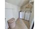 Laundry room with washer, dryer, and storage shelves at 209 Palmetto Blvd, Edisto Beach, SC 29438