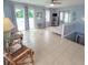 Living room with tiled floors and access to a deck at 209 Palmetto Blvd, Edisto Beach, SC 29438