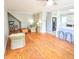 Bright living room with hardwood floors, wicker furniture, and views into kitchen at 209 Palmetto Blvd, Edisto Beach, SC 29438