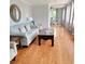 Light-filled living room with hardwood floors, comfortable seating, and a view to the dining area at 209 Palmetto Blvd, Edisto Beach, SC 29438