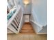 Wooden staircase leading downstairs with a white railing and light walls at 209 Palmetto Blvd, Edisto Beach, SC 29438