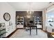 Home office with a large desk, built-in shelving, and hardwood floors at 2186 Midden Dr, Mount Pleasant, SC 29466
