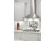 Stainless steel range hood above gas cooktop in modern kitchen at 2186 Midden Dr, Mount Pleasant, SC 29466