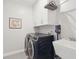 Modern laundry room featuring a front load washer and dryer, a utility sink, and ample storage at 2186 Midden Dr, Mount Pleasant, SC 29466
