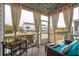 Relaxing screened porch with comfortable seating and string lights at 2186 Midden Dr, Mount Pleasant, SC 29466