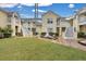 Building exterior showcasing yellow siding, white stairs, and landscaping at 2345 Tall Sail Dr # C, Charleston, SC 29414