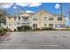 Yellow building exterior with parking lot in front and landscaping at 2345 Tall Sail Dr # C, Charleston, SC 29414