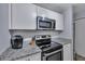 Kitchen with microwave, stovetop, and granite countertops at 2345 Tall Sail Dr # C, Charleston, SC 29414