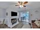 Living room with fireplace, TV, and view into dining area and bedroom at 2345 Tall Sail Dr # C, Charleston, SC 29414