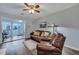 Living room with brown leather furniture and view of sunroom at 2345 Tall Sail Dr # C, Charleston, SC 29414