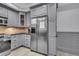 Gray kitchen with stainless steel refrigerator and cabinetry at 2371 Shipwatch Rd, Kiawah Island, SC 29455