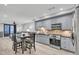 Modern kitchen with gray cabinets, granite countertops and stainless steel appliances at 2371 Shipwatch Rd, Kiawah Island, SC 29455