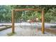 Wooden swing set and playground equipment in a sandy play area at 2371 Shipwatch Rd, Kiawah Island, SC 29455