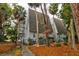 A-frame style building with grey siding, and a walkway leading to the entrance at 251 Driftwood Ln # 251, Edisto Island, SC 29438
