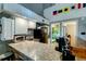 Compact kitchen with granite countertops and stainless steel appliances at 251 Driftwood Ln # 251, Edisto Island, SC 29438