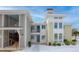 Modern condo building entrance with blue door and snowy ground at 267 Alexandra # 6, Mount Pleasant, SC 29464