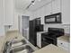 White kitchen cabinets, black appliances, and a laundry closet at 267 Alexandra # 6, Mount Pleasant, SC 29464