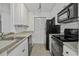 Modern kitchen with white cabinets, black appliances, and tile backsplash at 267 Alexandra # 6, Mount Pleasant, SC 29464