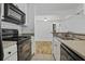Modern kitchen with white cabinets, black appliances, and tile backsplash at 267 Alexandra # 6, Mount Pleasant, SC 29464