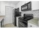 Modern kitchen with white cabinets, black appliances, and tile backsplash at 267 Alexandra # 6, Mount Pleasant, SC 29464