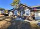 Brick ranch home with attached garage, and American flag at 303 Swamp Fox Ln, Goose Creek, SC 29445