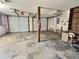 Large garage with shelving, workbench, and double garage doors at 303 Swamp Fox Ln, Goose Creek, SC 29445