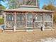 Wooden gazebo with screened sides and seating area at 303 Swamp Fox Ln, Goose Creek, SC 29445