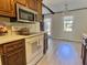 Eat-in kitchen with wood cabinets, updated flooring and view to backyard at 303 Swamp Fox Ln, Goose Creek, SC 29445