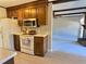 Kitchen features wood cabinets, updated flooring, and stainless steel appliances at 303 Swamp Fox Ln, Goose Creek, SC 29445