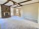 Open living room showcasing a fireplace, wood beams, and access to other rooms at 303 Swamp Fox Ln, Goose Creek, SC 29445