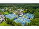 Aerial view of a community featuring a pool, tennis courts, clubhouse, and many trees at 3100 Sonja Way, Mount Pleasant, SC 29466