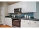 Stylish kitchen with white cabinets, blue mosaic backsplash, and stainless steel appliances at 3100 Sonja Way, Mount Pleasant, SC 29466