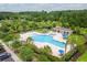 Aerial view of a large community pool with lounge chairs, umbrellas, and people enjoying a swim on a sunny day at 3100 Sonja Way, Mount Pleasant, SC 29466