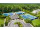 Aerial view of community tennis courts featuring multiple well-maintained courts, landscaping, and a nearby clubhouse at 3100 Sonja Way, Mount Pleasant, SC 29466