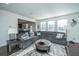 Sectional sofa, large windows, and view of kitchen and dining area at 3157 Timberline Dr, Johns Island, SC 29455