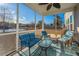 Screened porch with lake view, wicker furniture, and ceiling fan at 3157 Timberline Dr, Johns Island, SC 29455