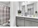 Bathroom with double vanity, gray cabinets, and shower/tub at 3765 Sawmill Ct, Mount Pleasant, SC 29429