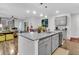 Open concept kitchen with island, gray cabinets, and views of living room at 3765 Sawmill Ct, Mount Pleasant, SC 29429