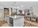 Open concept kitchen and dining area with granite island and hardwood floors at 3765 Sawmill Ct, Mount Pleasant, SC 29429