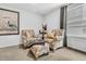 Cozy sitting area with two armchairs, ottoman, and large artwork at 3765 Sawmill Ct, Mount Pleasant, SC 29429