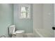 Bathroom featuring a toilet, a tub, and white tiling at 4329 Spur St, North Charleston, SC 29405
