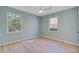 Bedroom features hardwood floors, a ceiling fan, and two bright windows at 4329 Spur St, North Charleston, SC 29405